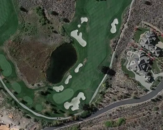 Aerial view of a hole at Montreux Golf Club with bunkers and water